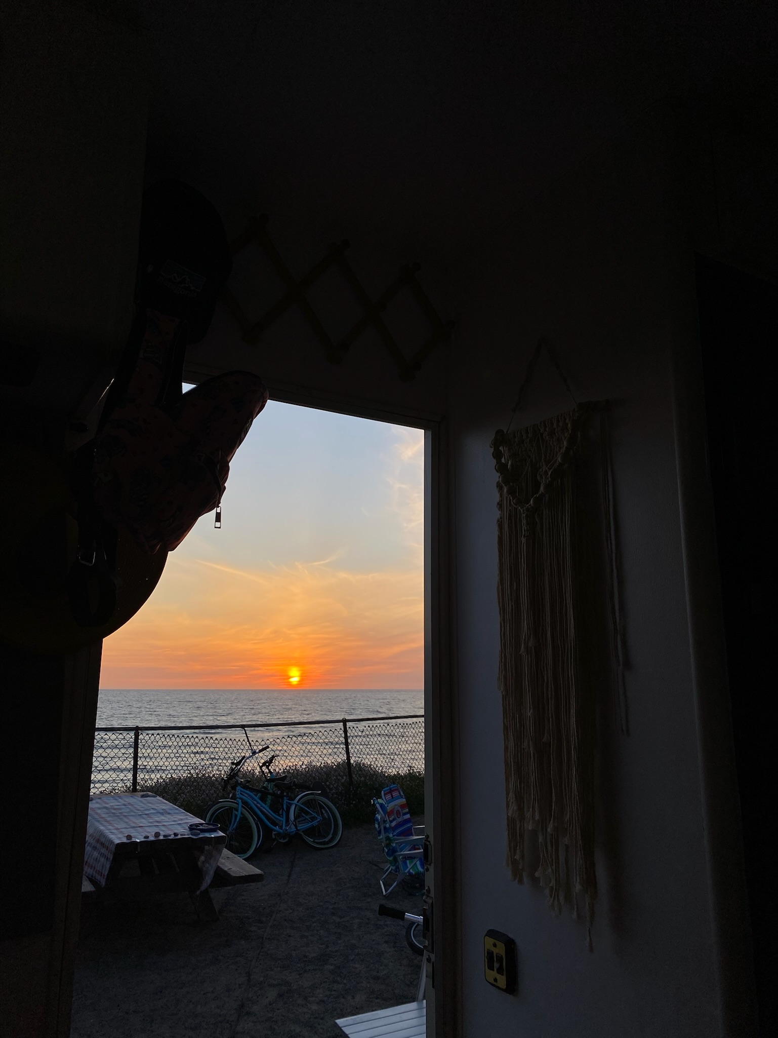Sunset view from inside an RV by the coast