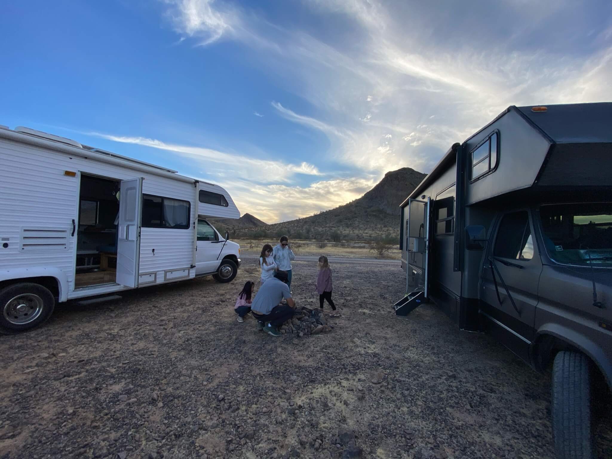 Two RVs camping in a desert landscape in the American Southwest