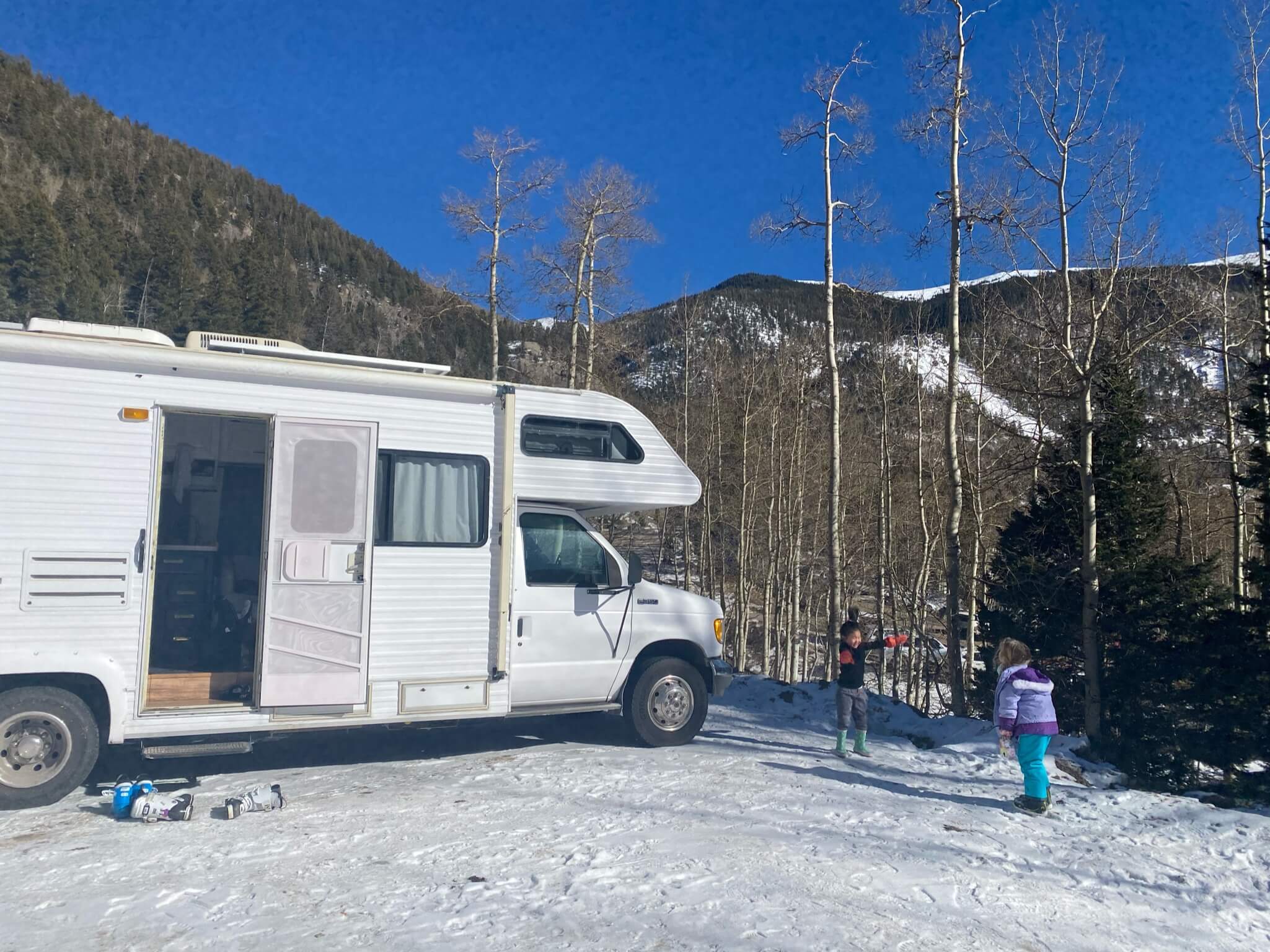 Goldie parked in a snowy mountain campsite with the family